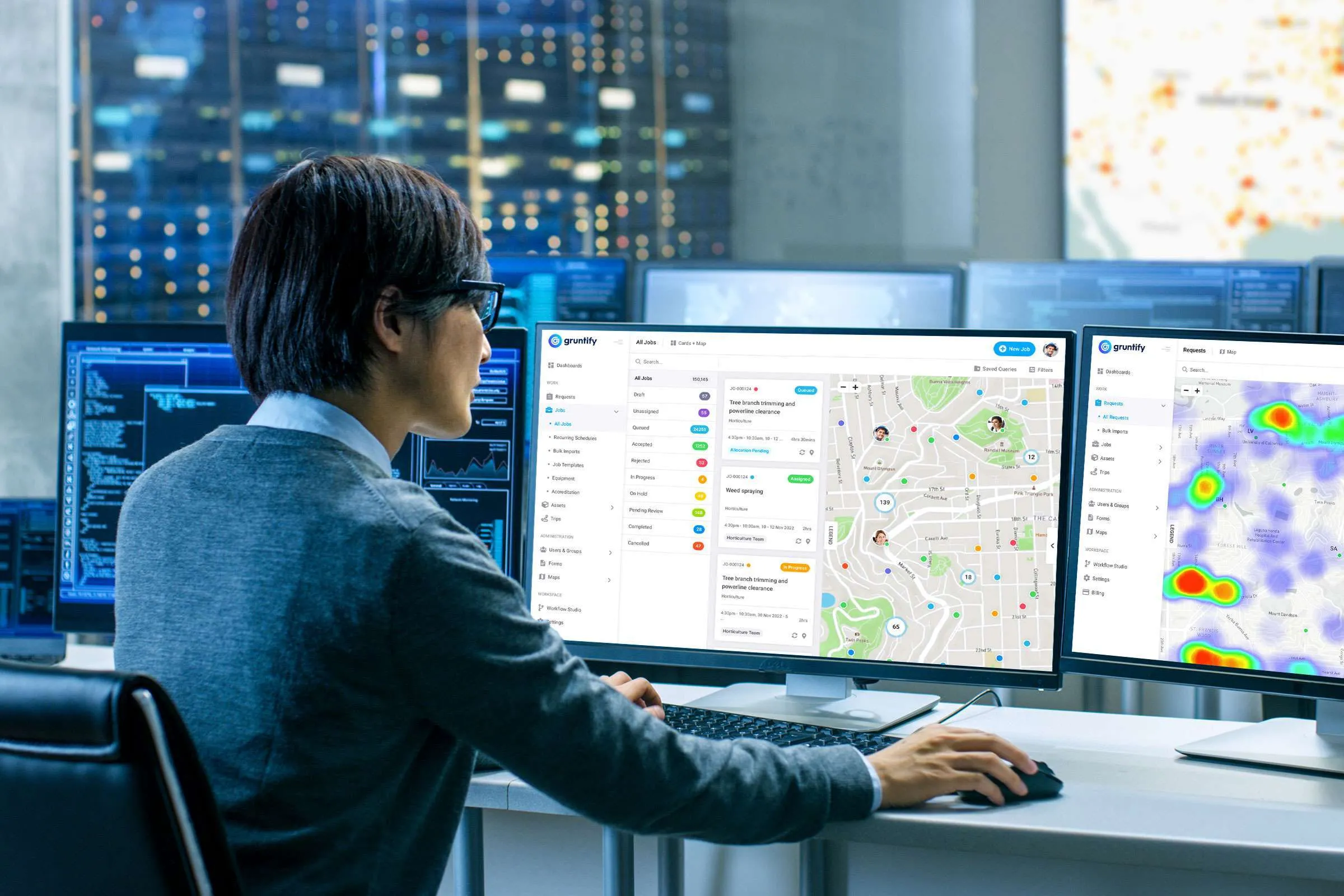 An operator monitoring live incident maps in a control room