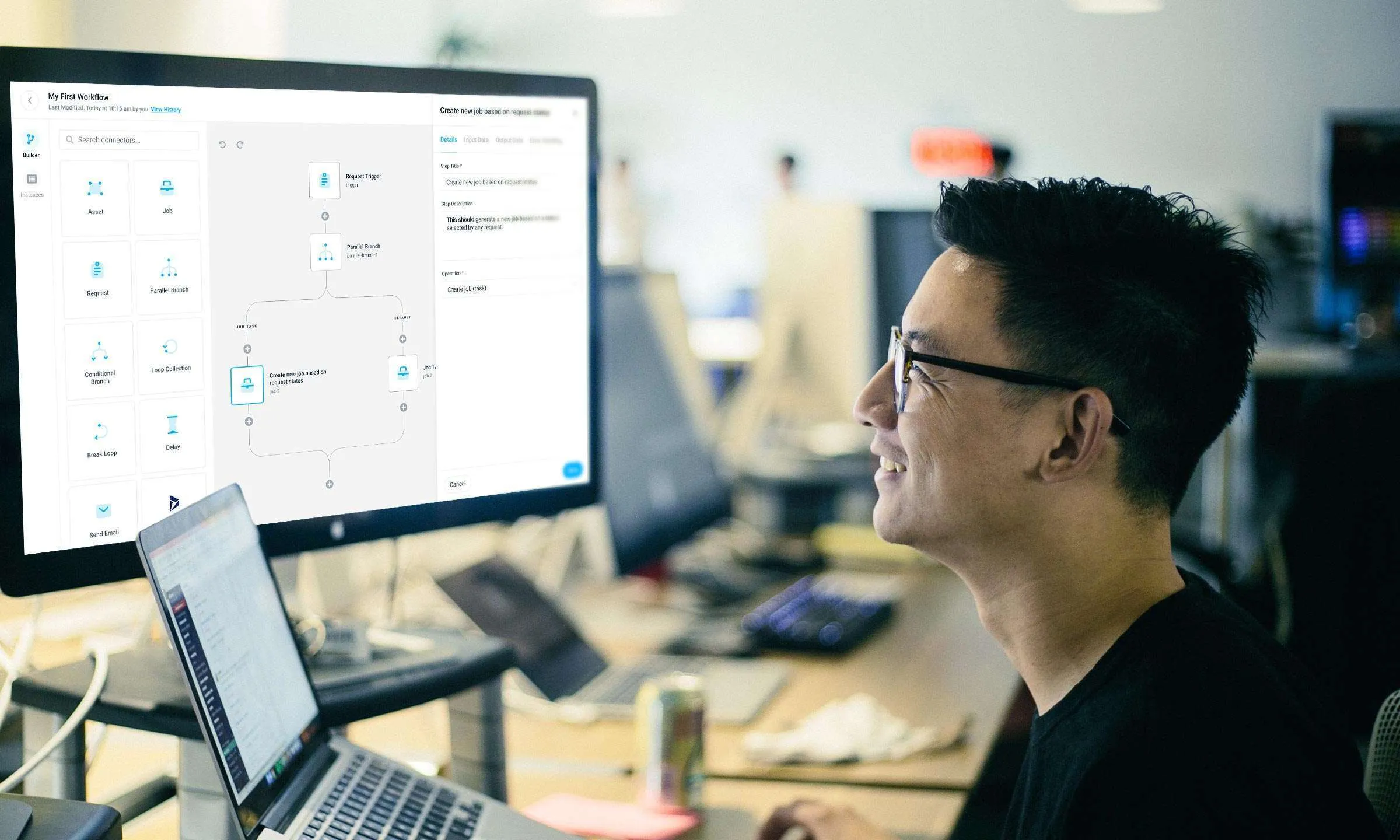 Man reviewing a Gruntify workflow automation builder on a monitor, showing a branching job-creation flow