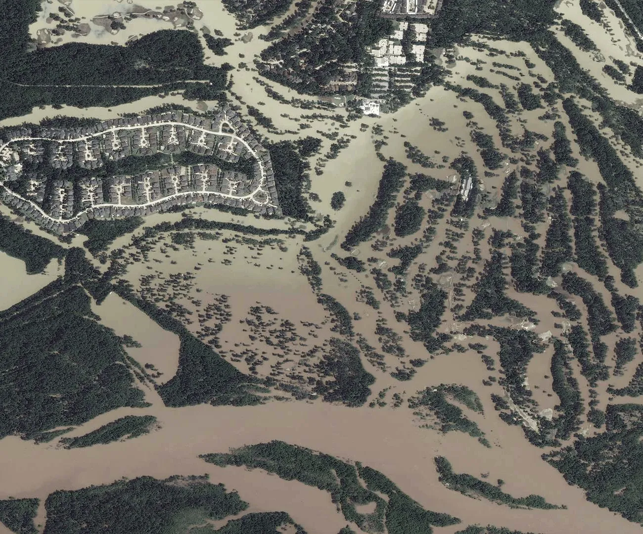 The same neighbourhood submerged by flooding after Hurricane Harvey