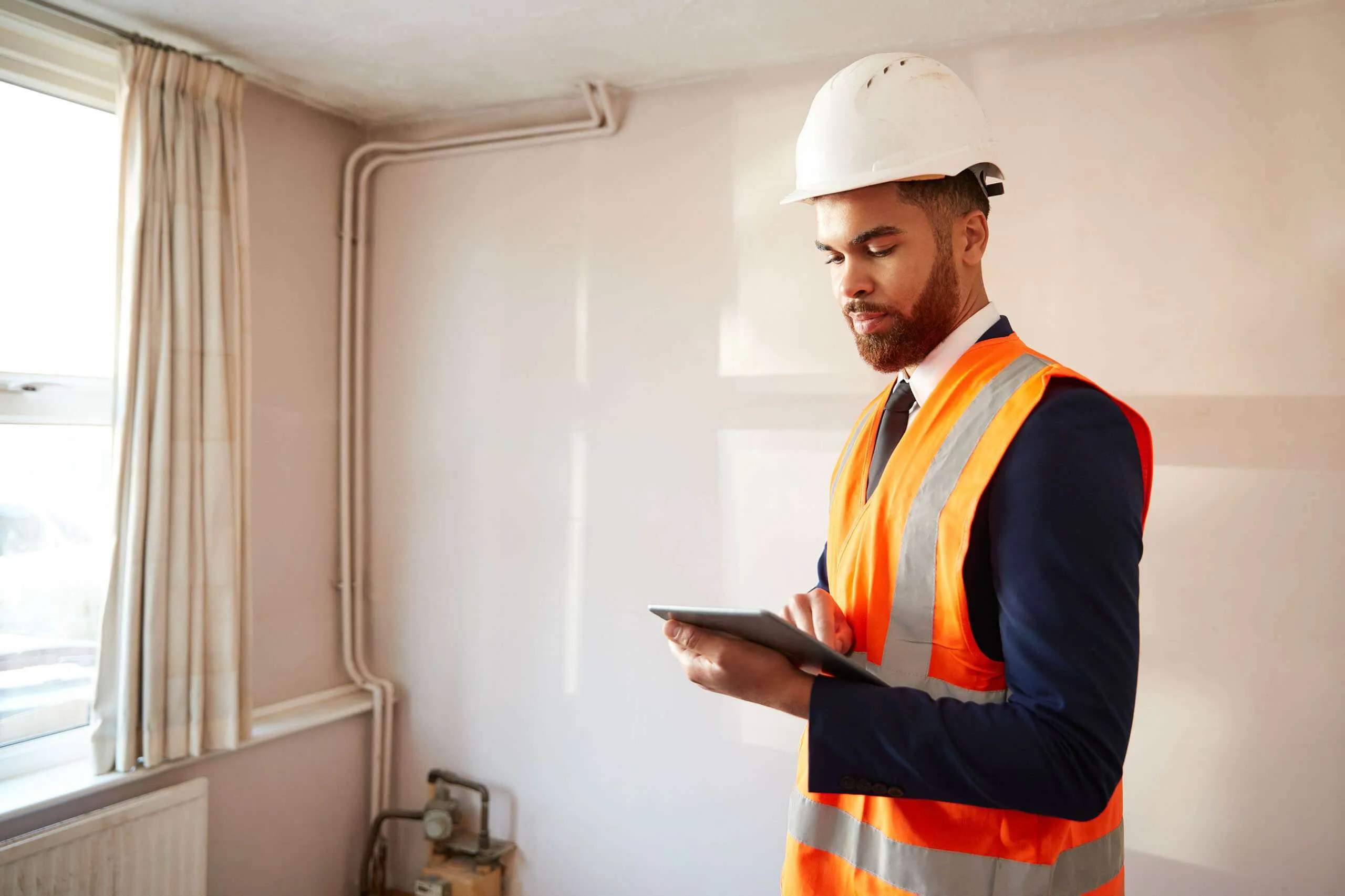 A building surveyor inspecting the exterior of a house