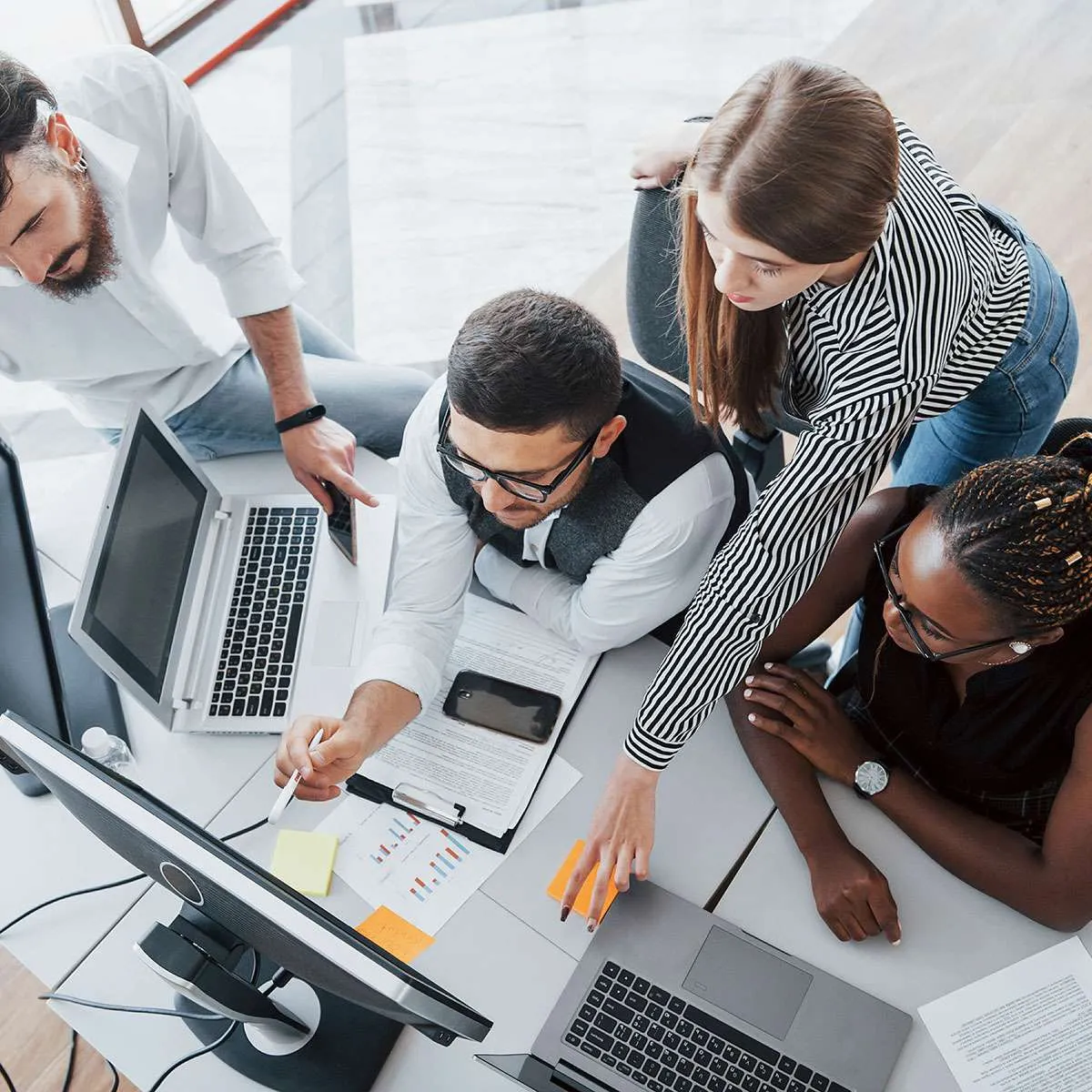 A team planning telecommunications maintenance in an office