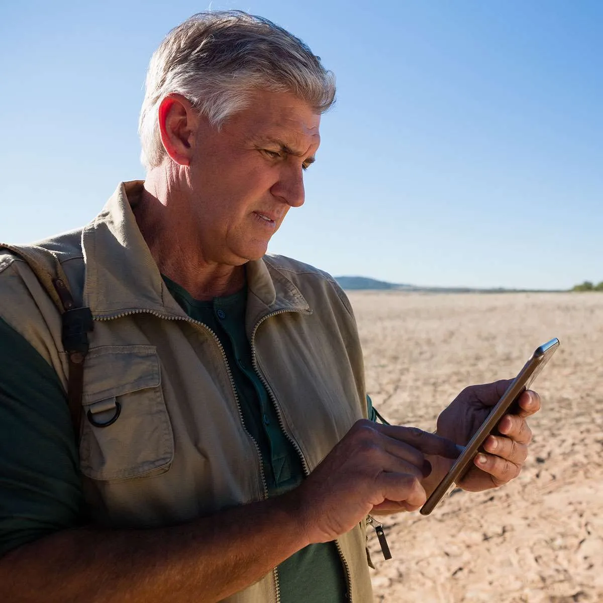 A field worker submitting permit documents from a tablet