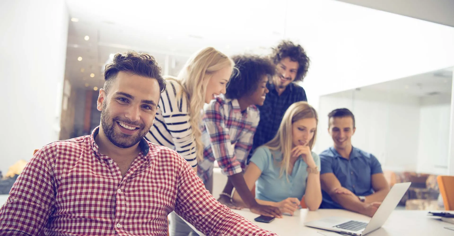 A Gruntify team member smiling during a team meeting