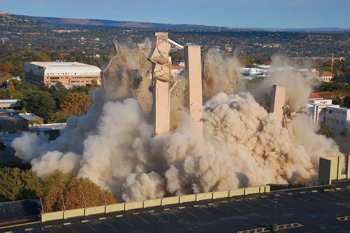 A building demolition collapsing in dust and debris