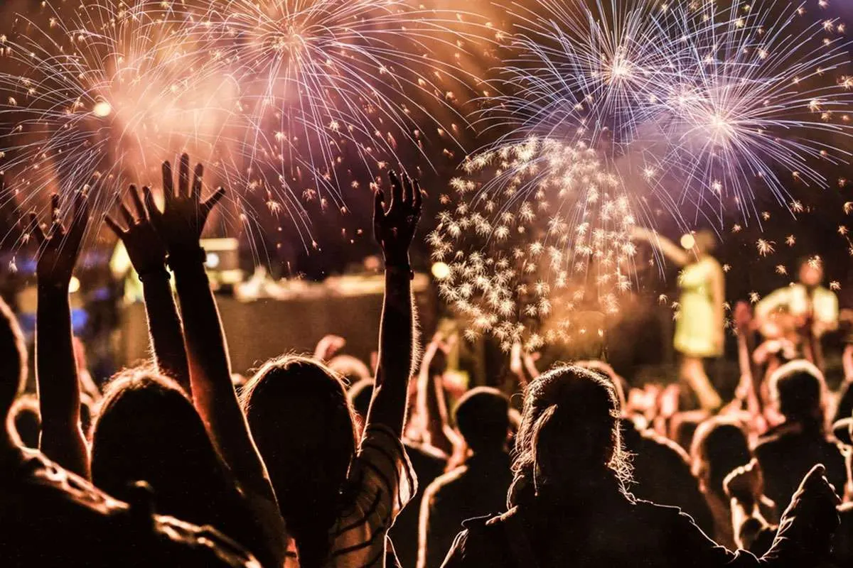 A fireworks display over a waterfront