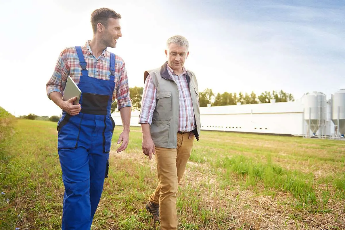 An agricultural inspector talking with a farmer