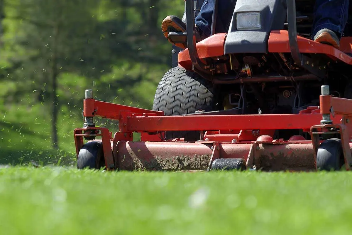 A ride-on mower performing yard maintenance
