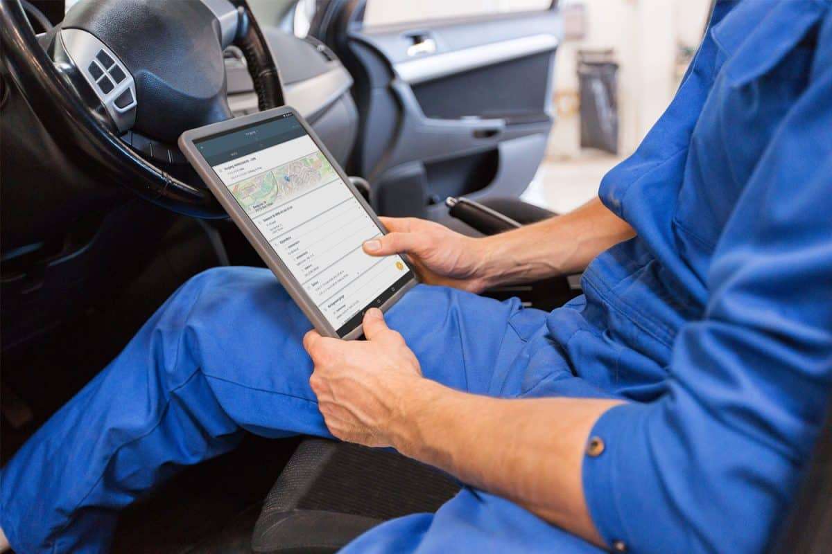 man using field service app in car