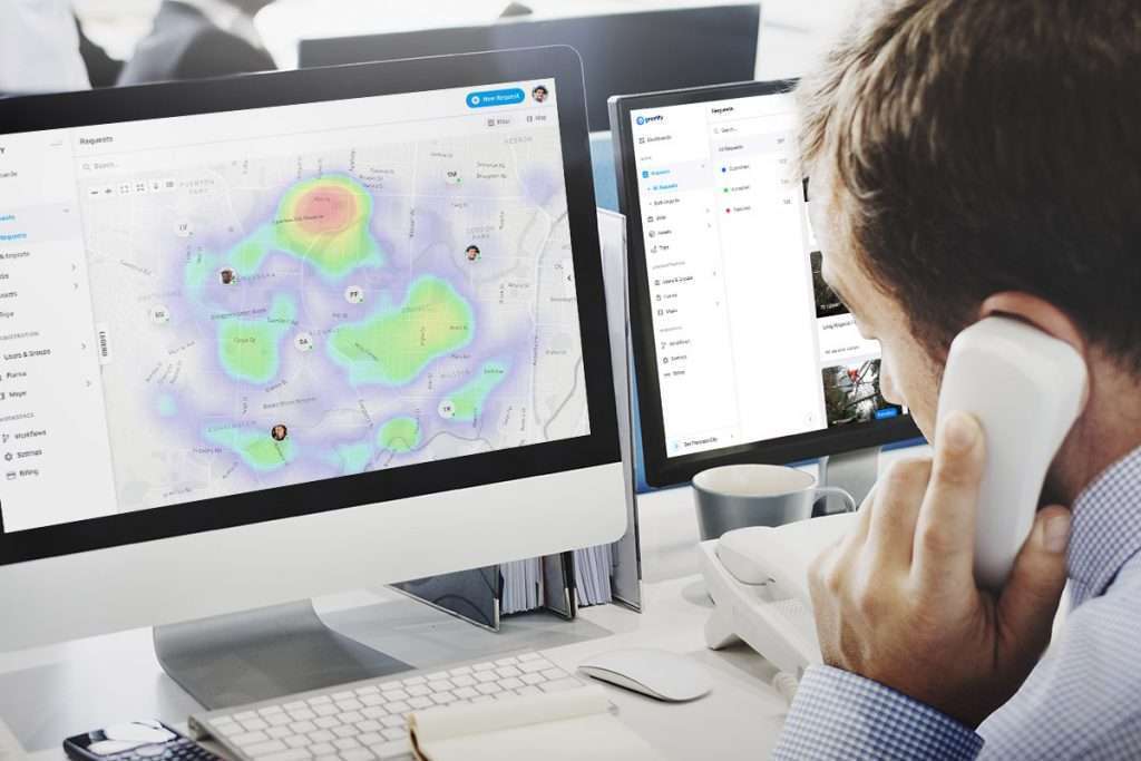 man looking at screen displaying natural disaster heatmap