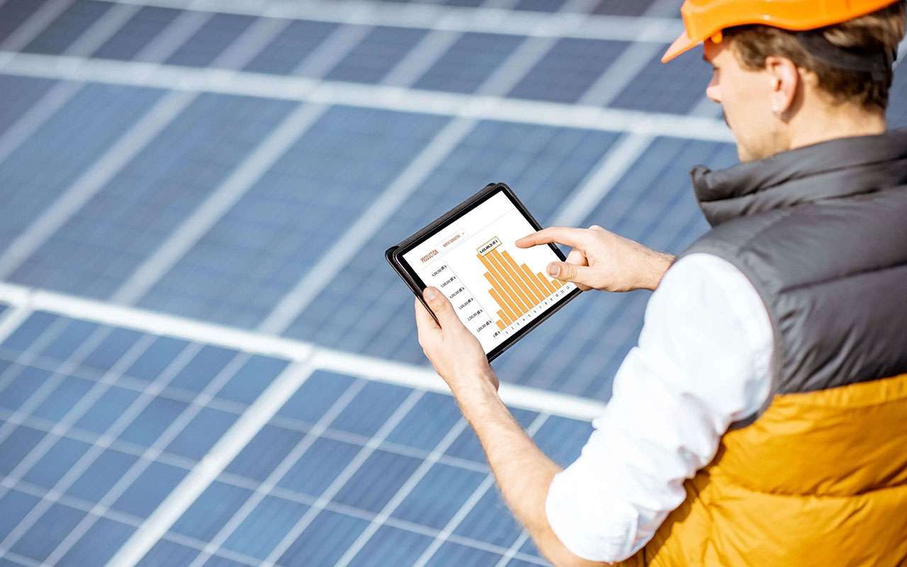 man performing predictive maintenance solar panel inspection