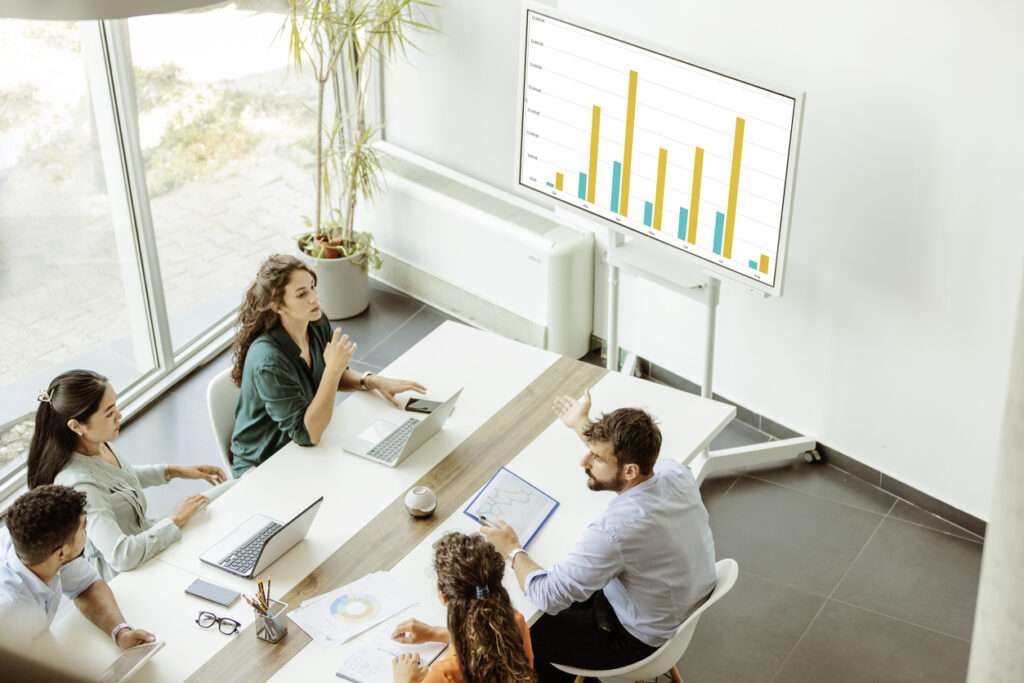 Group of business owners having a meeting in an office, discussing data involving their BPM.