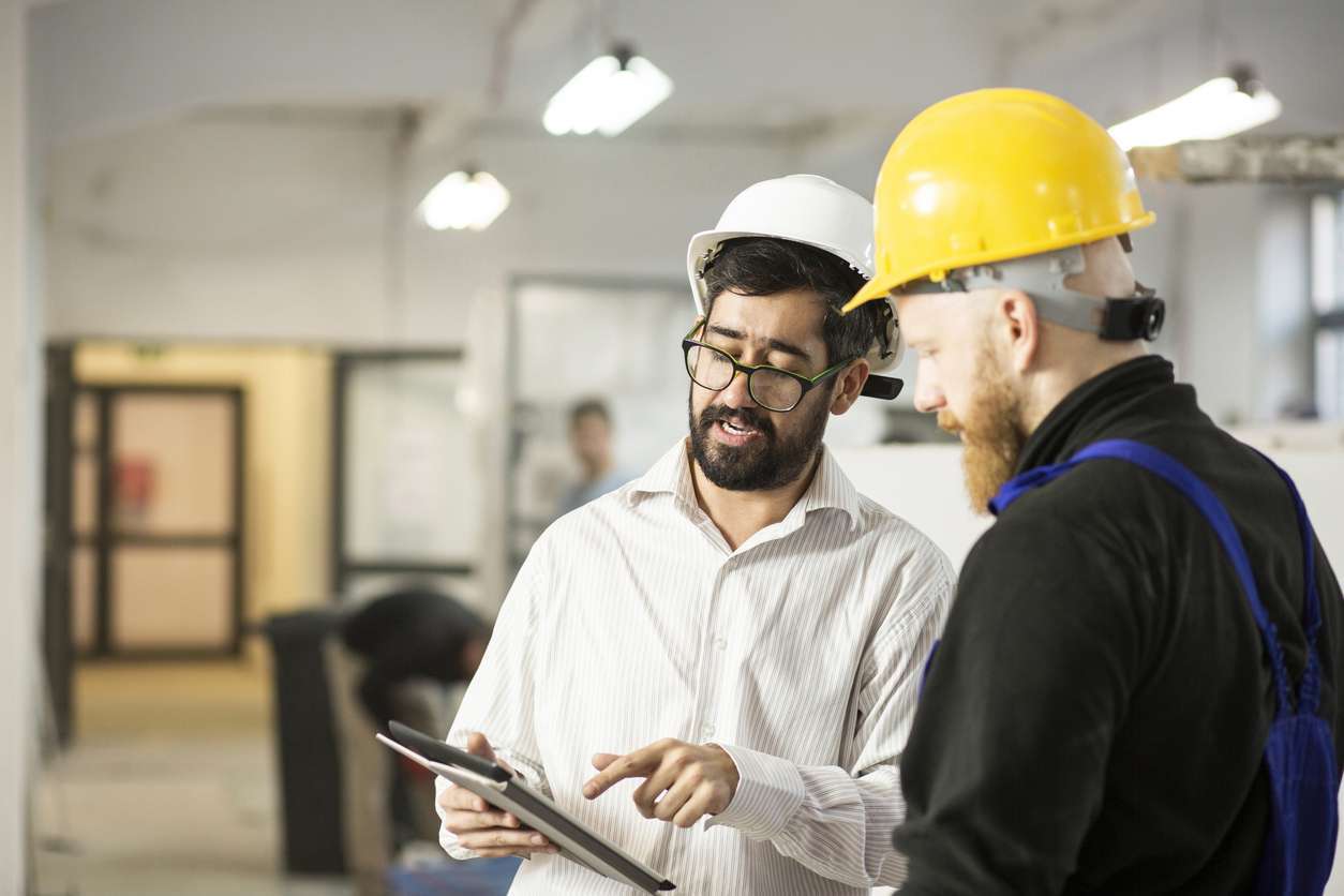 Field service professionals managing tasks and schedules using a tablet device.