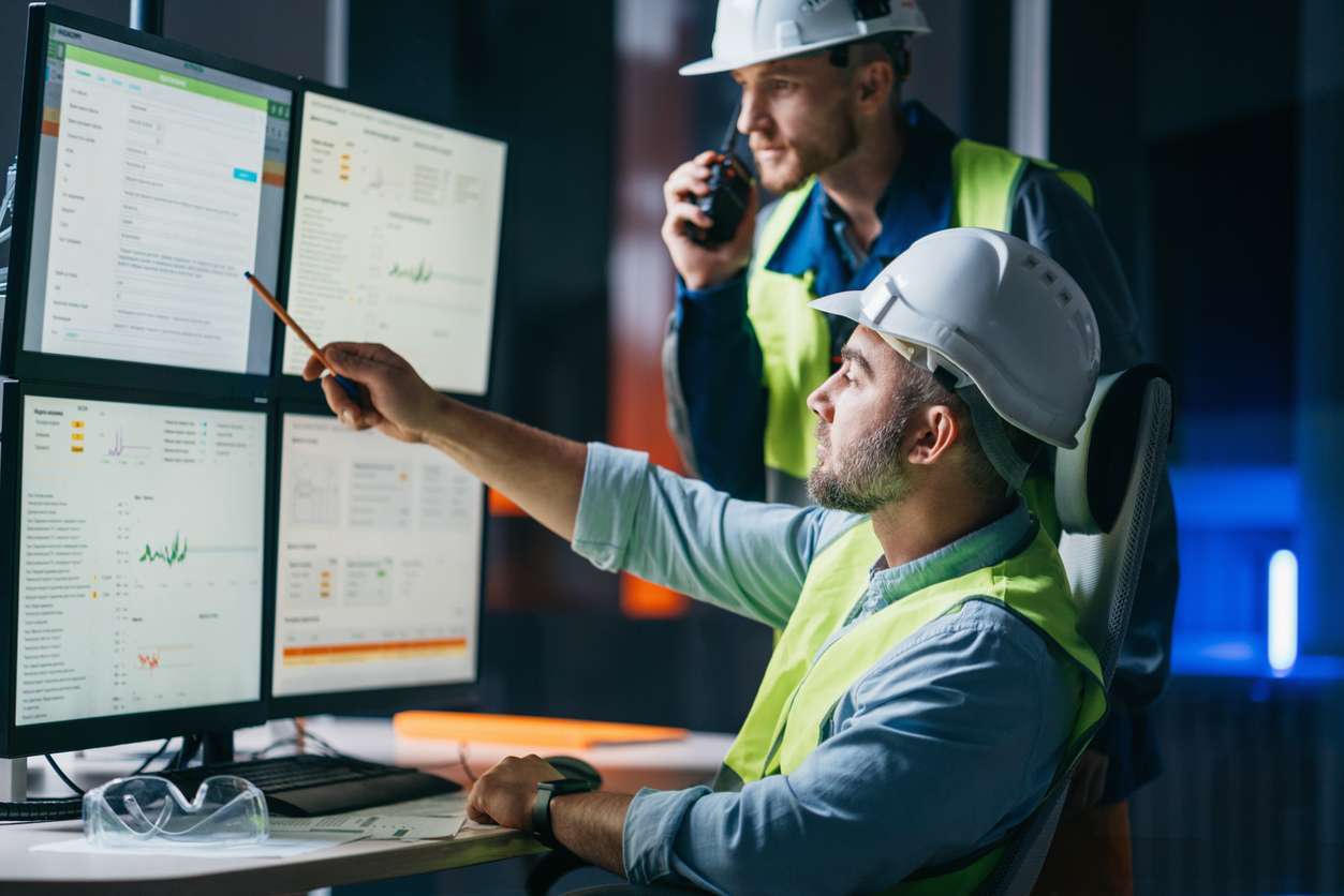 Field service managers tracking employees and tasks using field service automation software on a computer.