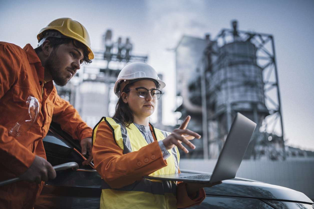 Optimizing field service workflows - Field service managers using a laptop to coordinate with teammembers.