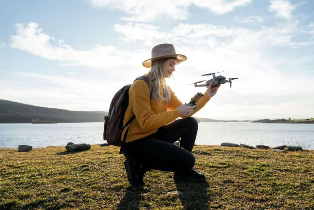 full shot woman holding drone outdoors checking environmental regulations