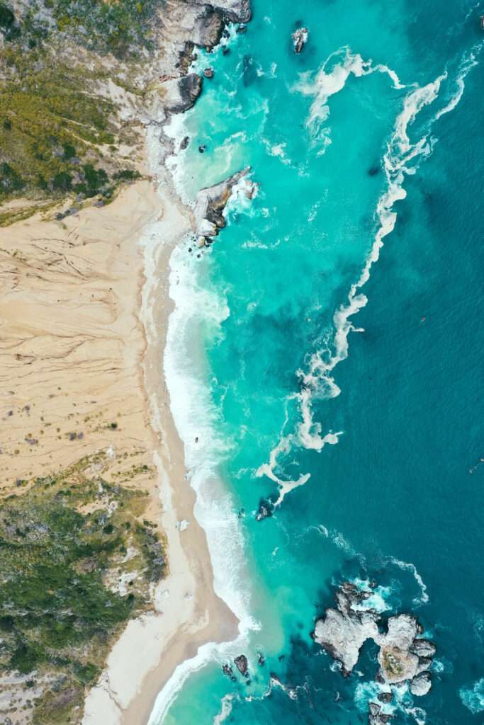 vertical overhead shot beautiful shoreline sea with blue clean water sandy beach environmental ocean monitoring