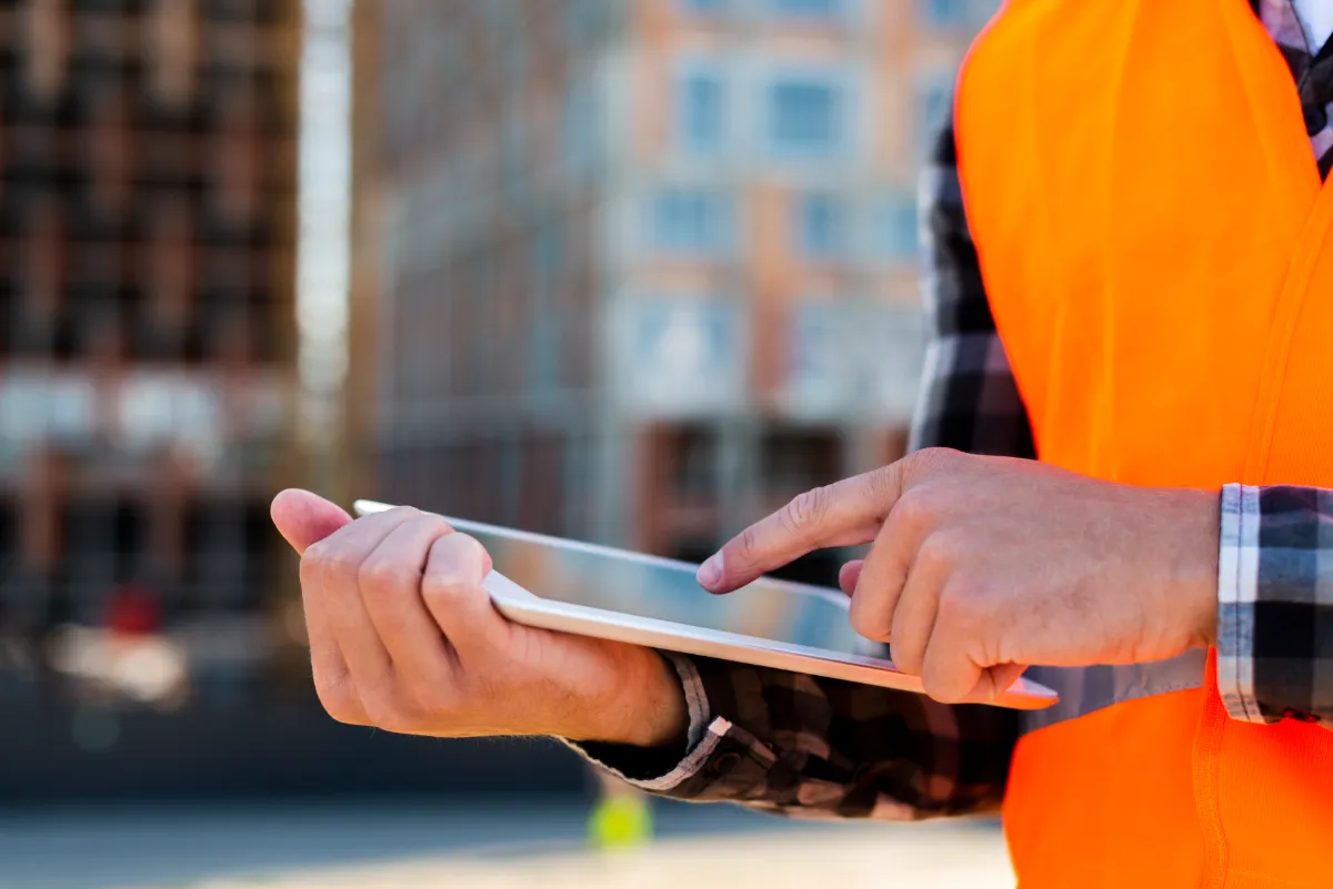 close up of engineer using field service app on tablet